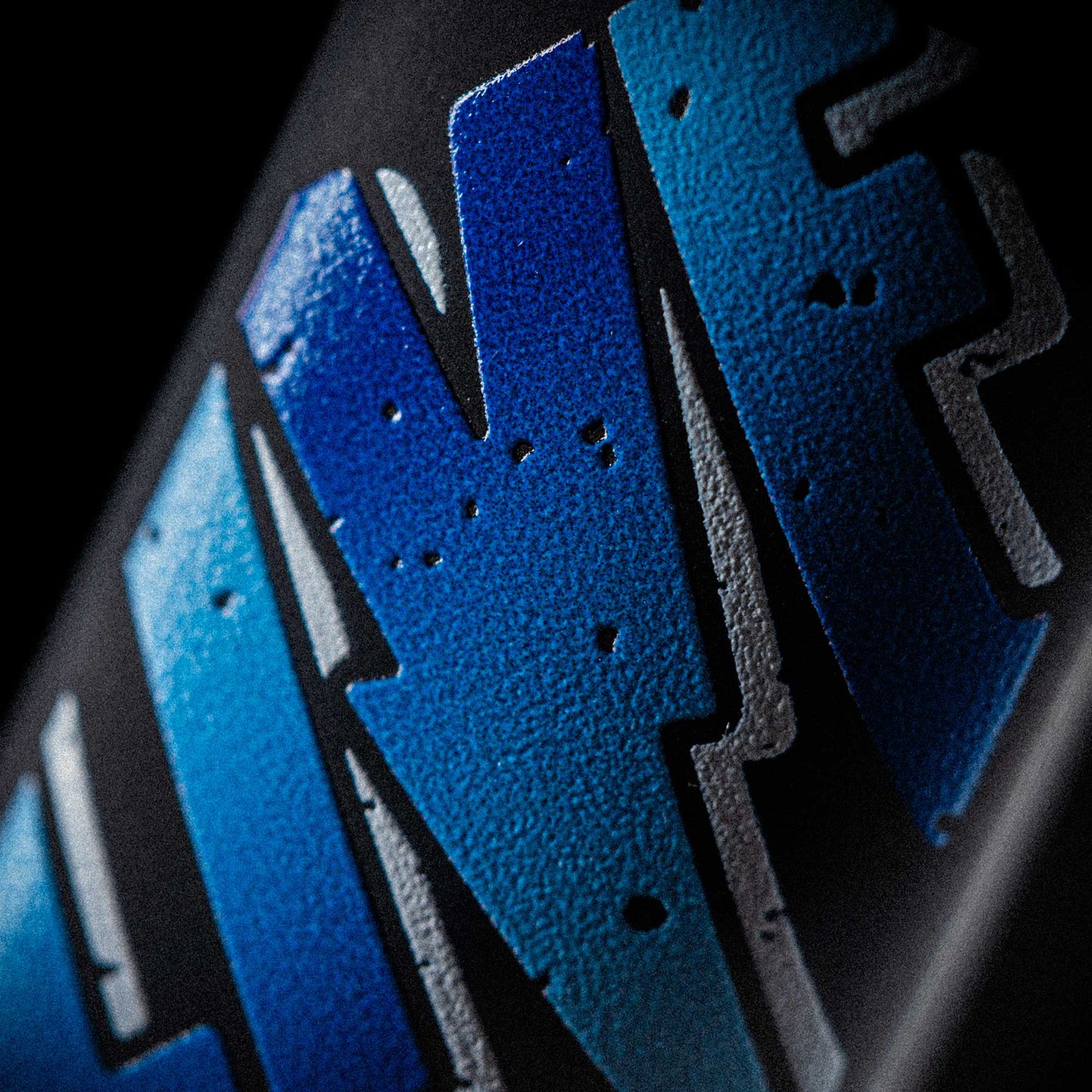 Macro shot of textured 'LIVE' branding on Rockstar Live vape pen packaging, showcasing bold street-style design and product identity.