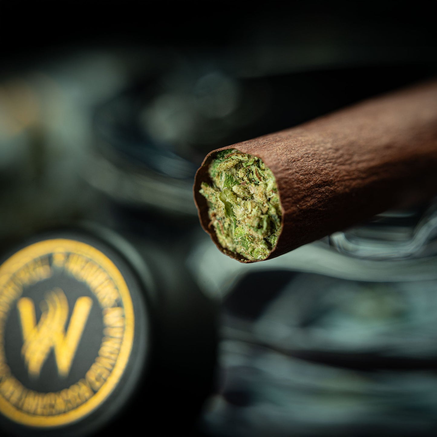 Macro shot of Rockstar Weavers TEK3 Blunt open end revealing green flower, highlighting premium rosin-infused cannabis content.